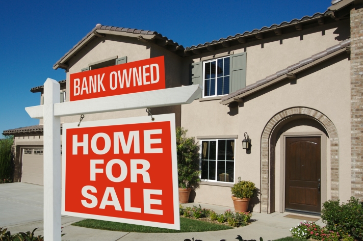 Bank Owned Home For Sale Sign In Front Of New House
